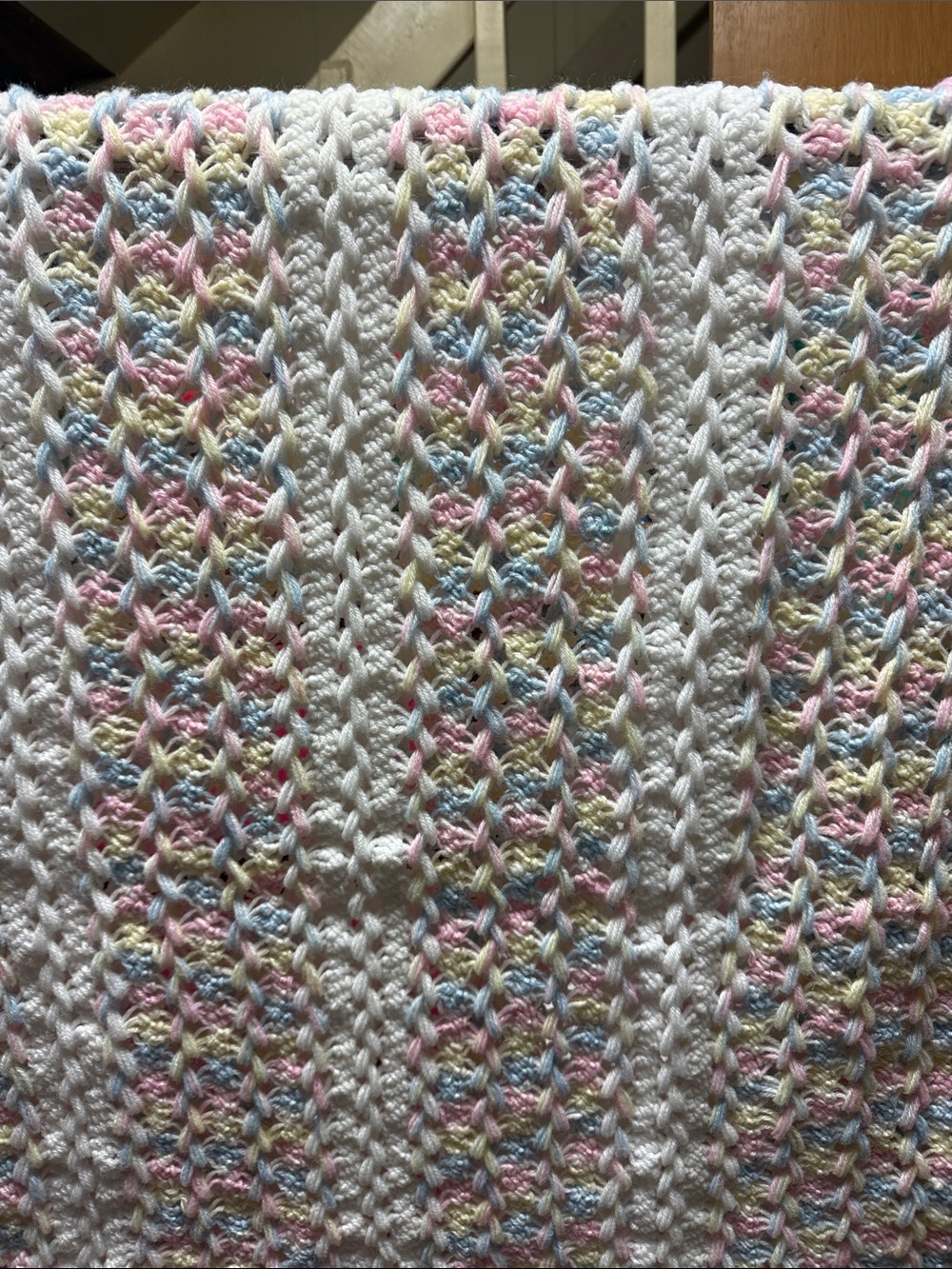 White Crochet Baby Throw with Pastel Pink, Blue, and Yellow Accents